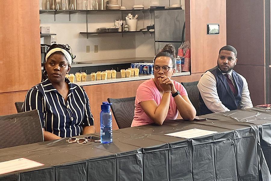 Three attendees seated at a table during the Sankofa mentorship program luncheon