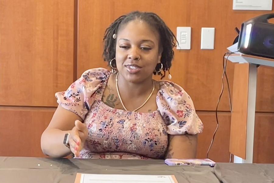 Attendee seated at a table during the Sankofa mentorship program luncheon