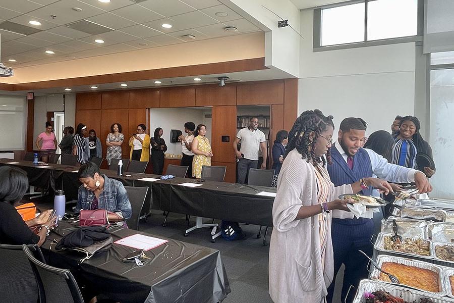 Attendee at the buffet during the Sankofa mentorship program luncheon